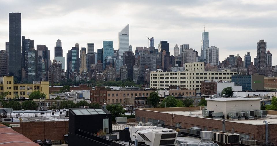 City skyline of towers over low rooftops