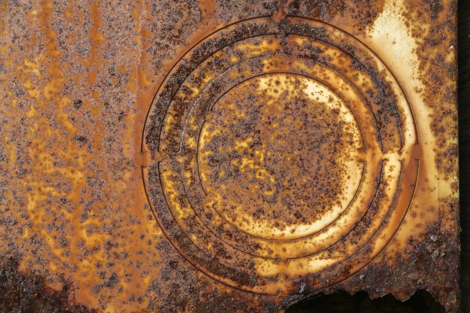 Rusted metal lid with concentric rings
